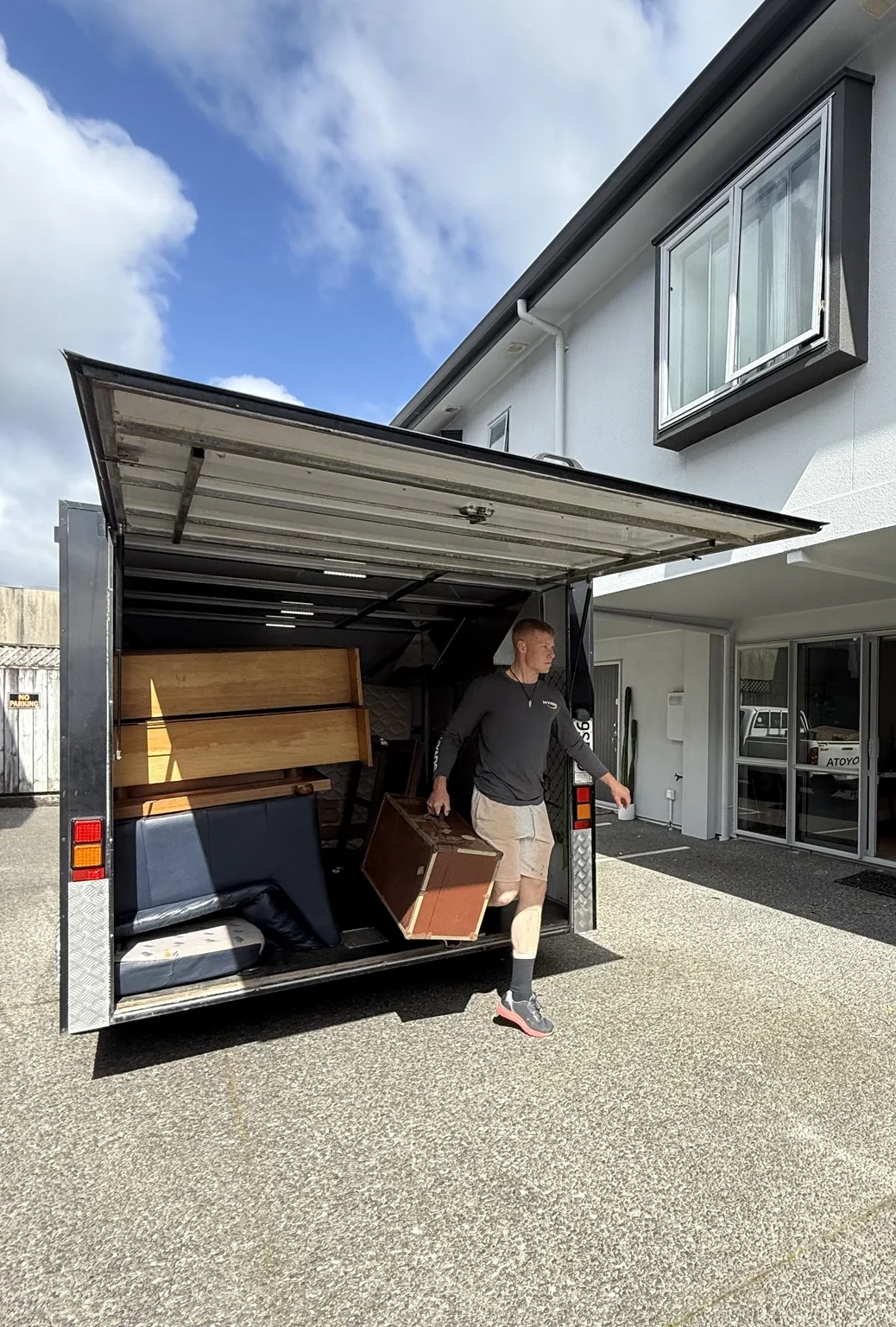 Furniture being unloaded from the TUT Transport enclosed trailer