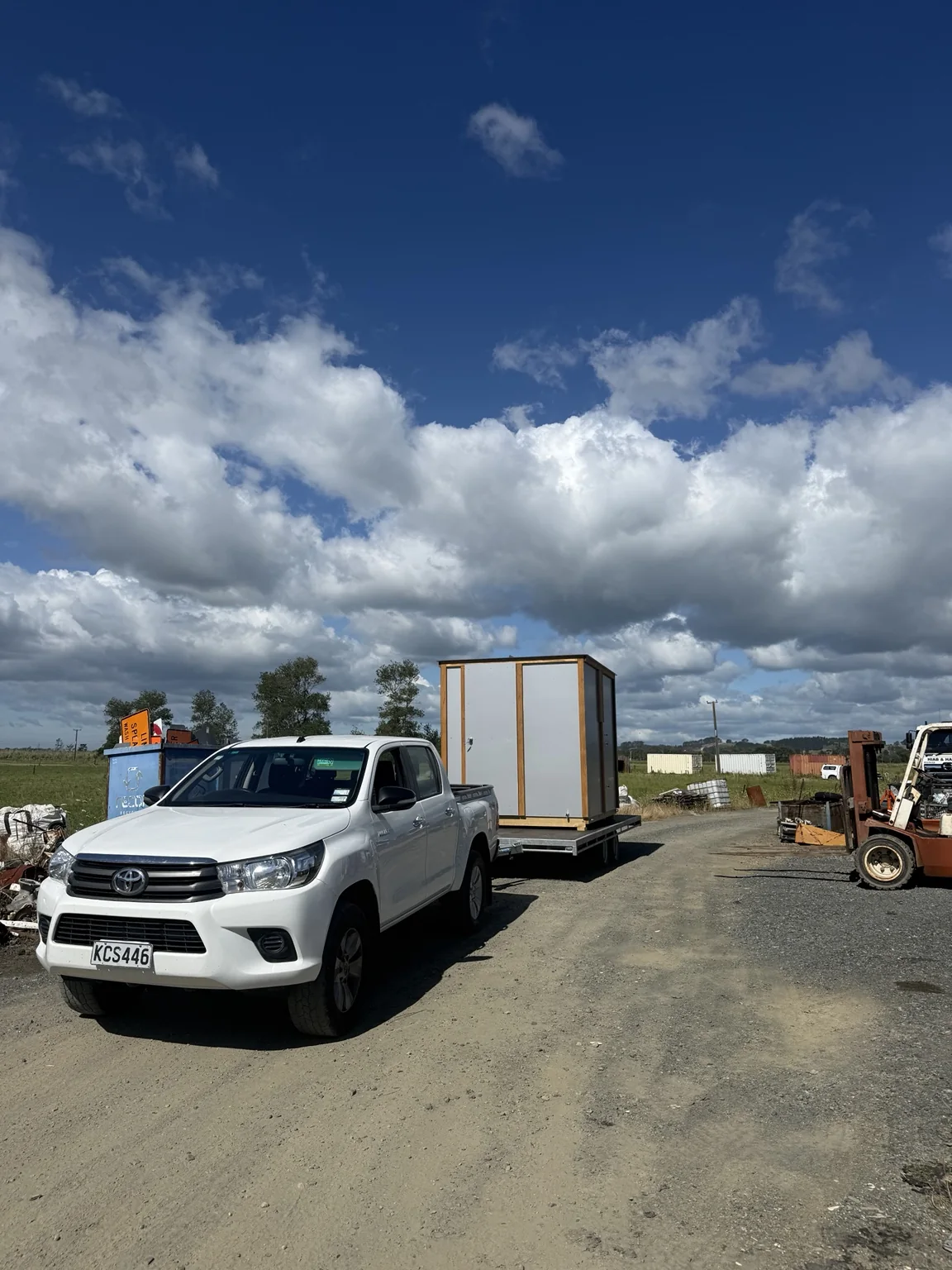 Large shed transported on an open tandem trailer